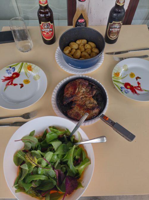 Baked potatoes. meat and salad